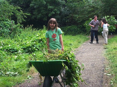 A junior conservation volunteer at Palace Road Nature Garden © Iain Boulton